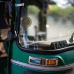 Sri Lanka tuk tuk: a green three-wheeler taxi close up on a Colombo street