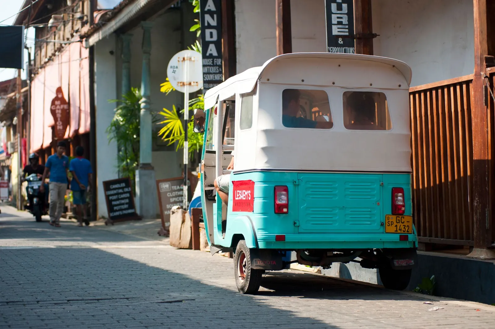 A tuk-tuk at the kerb, the cheapest short transfer in Sri Lanka