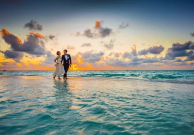 Sri Lanka honeymoon: a couple at the water's edge on a tropical beach at sunset