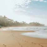 Sri Lanka in January: footprints on the sand at Mirissa beach in the early morning light