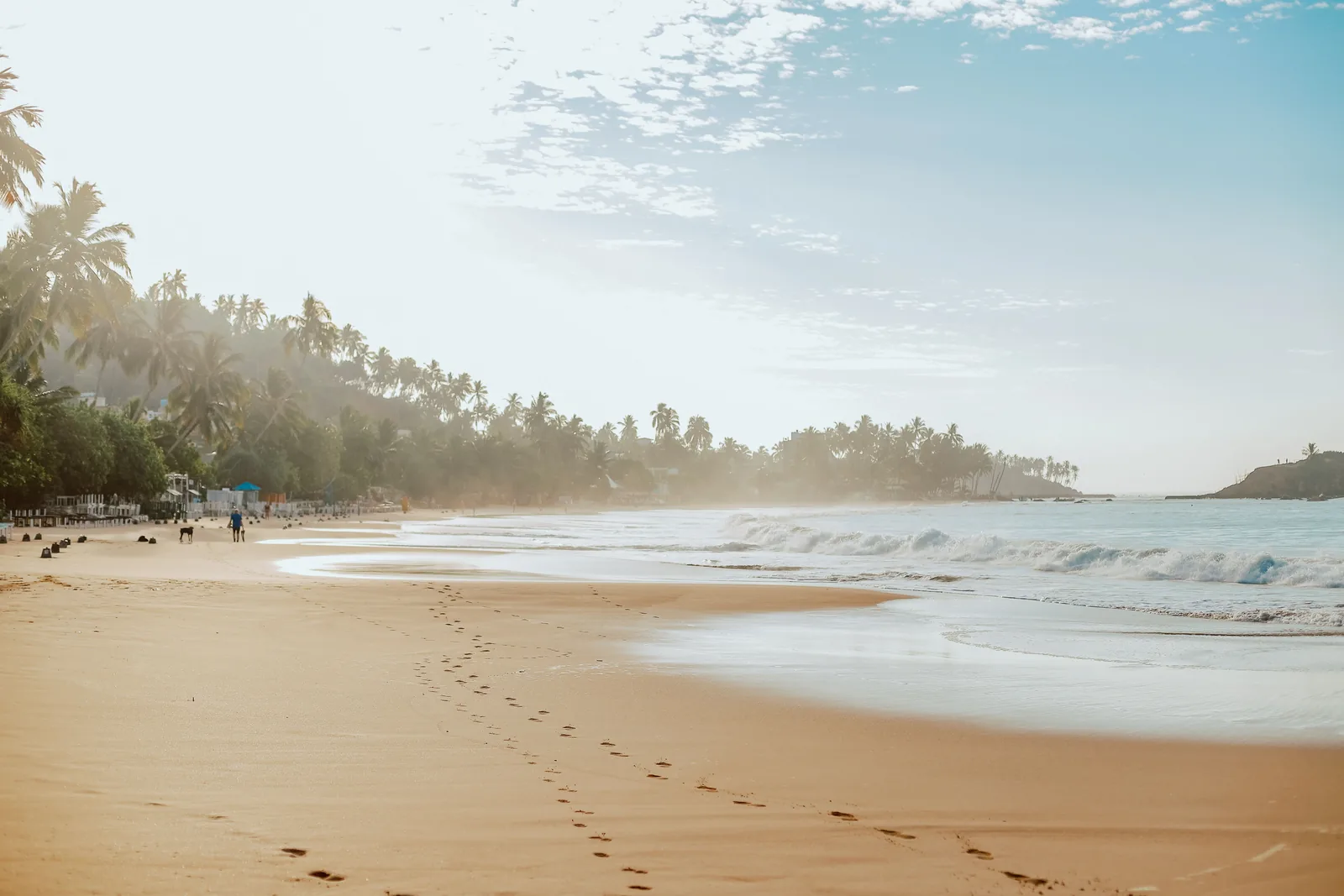 Sri Lanka in January: footprints on the sand at Mirissa beach in the early morning light