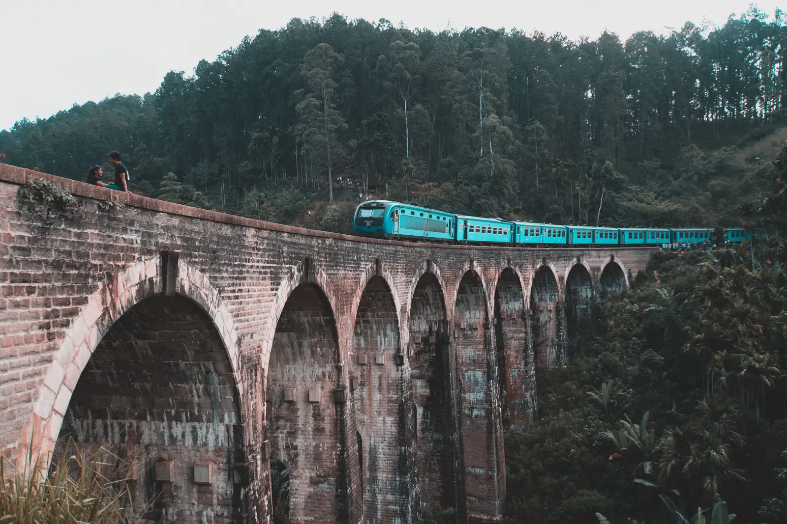 The blue hill country train crossing the Nine Arch Bridge at Ella