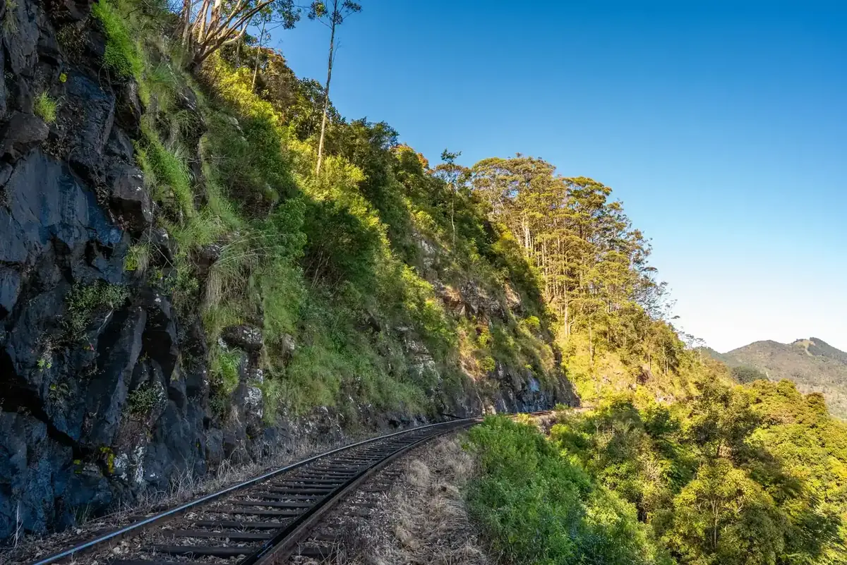 Railway track curving through green hills near Haputale in Sri Lanka's hill country