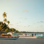 Sri Lanka in July: fishing boats pulled up on the sand at Trincomalee beach in the late afternoon