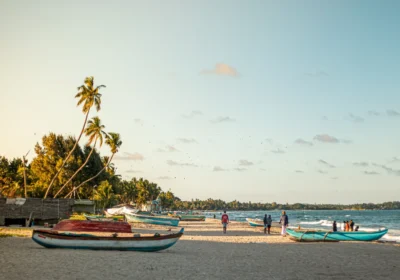 Sri Lanka in July: fishing boats pulled up on the sand at Trincomalee beach in the late afternoon